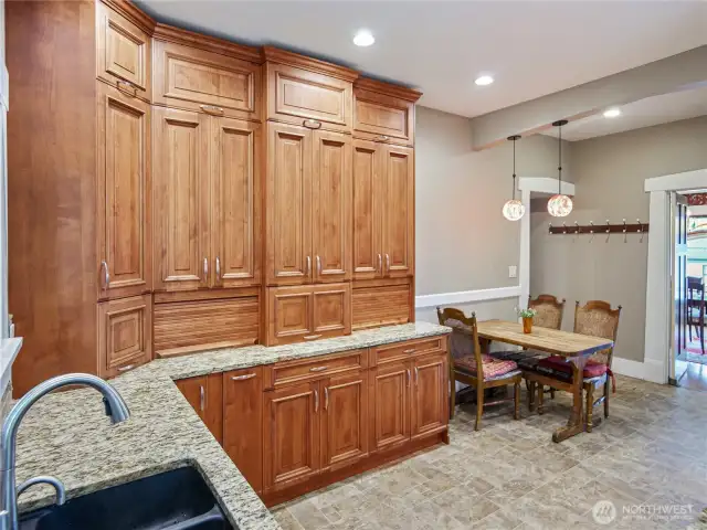 Cabinets with built-in appliance storage extend to the ceiling.