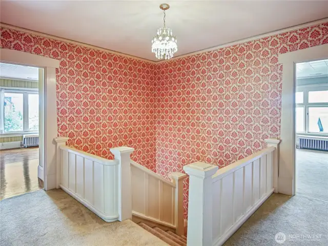 Walk up the stairs to four large bedrooms, a sunroom, and two bathrooms.
