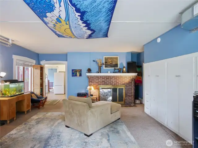 This is the large ADU family room with a working wood fireplace.