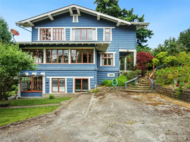 This is the south side of the house showing the concrete driveway and steps to the front.