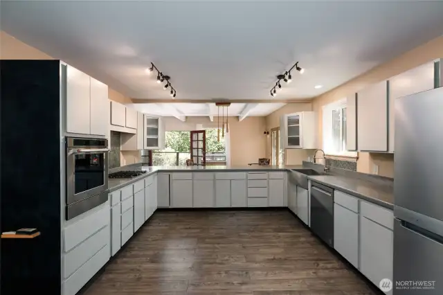 Ample kitchen has new appliances by KithenAid installed by Judd & Black. Wall oven, propane range, dishwasher and KitchenAir 4-door refrigerator. Waterproof laminate flooring in kitchen and eating area. New track ligthing installed.