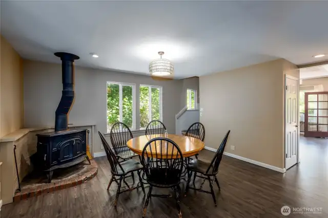 Eating area with wood stove off kitchen.