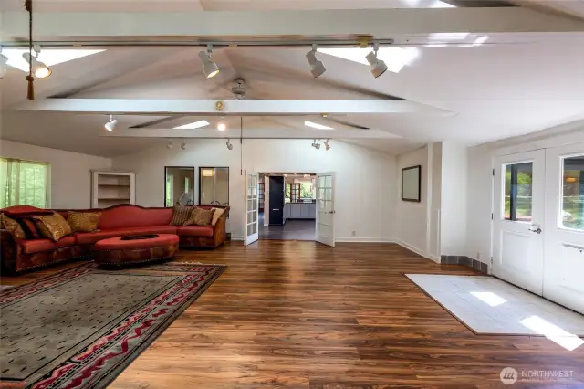 Extra-large bonus room with vaulted ceiling and skylights located directly off kitchen through the French doors. Another set of French doors lead to back area patio.