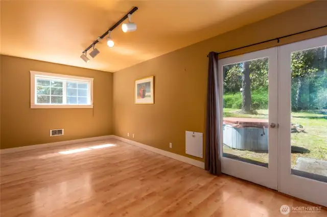 First floor bedroom could be considered a Primary bedroom suite with full bath. French doors lead to a patio.
