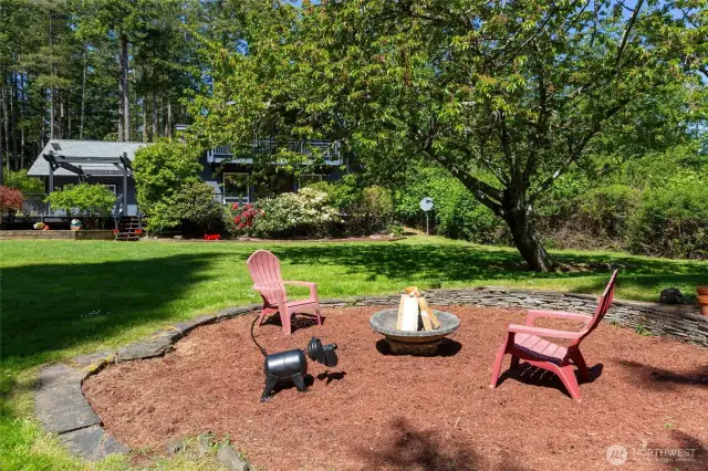Enjoy the fire pit on property that overlooks front gardens of house.