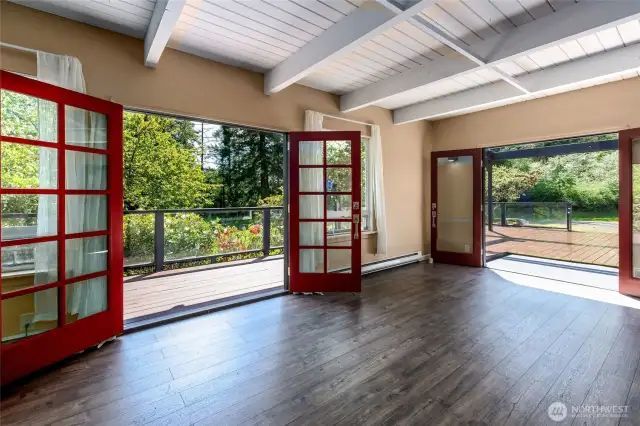 Living room has two sets of French doors that lead to large deck.