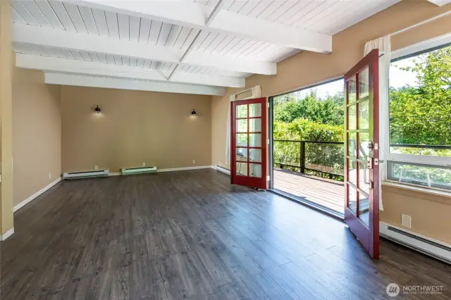 Living room has ship lap ceiling and Mohawk hand scraped look waterproof laminate flooring.