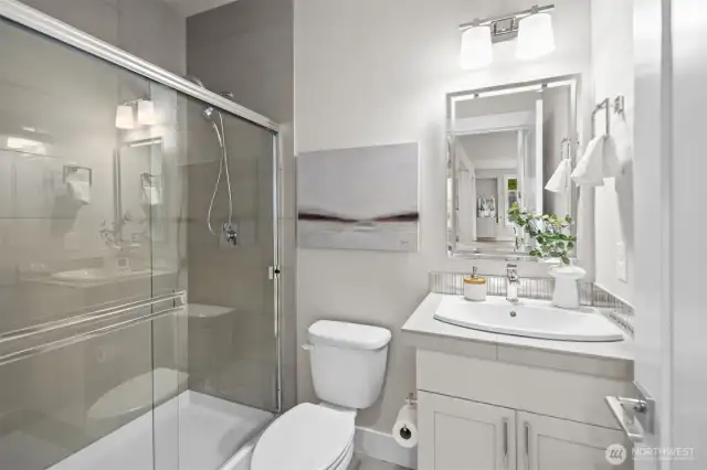 Stunning main floor 3/4 bath featuring elegant finishes and modern fixtures, offering both style and convenience.