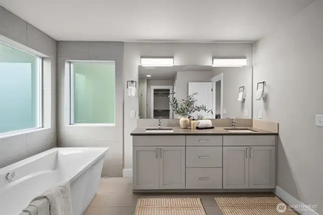 Indulge in the beautiful five-piece spa-like bathroom, a serene retreat designed for relaxation and unwinding, complete with luxurious finishes and a soothing ambiance.