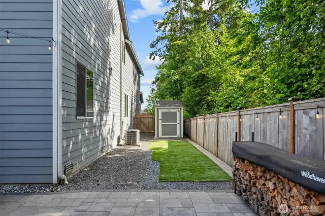 Enjoy a low-maintenance yard featuring durable turf and a spacious outbuilding, perfect for all your storage needs.