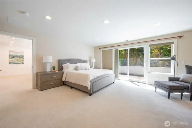 The second floor houses the primary bedroom with private balcony, high ceilings, stone fireplace, walk-in closet and five-piece bath.