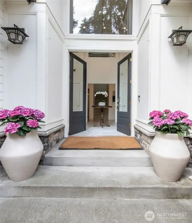 Welcome home! The private courtyard leads to the inviting double front doors where you step into the elegant, two story entryway complete with soaring ceilings, tile floor and custom, rod-iron detailing.  the elegant, two story entryway.