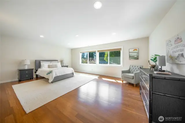 Second bedroom upstairs is extra-large with gleaming hardwood floors, high ceilings and a wall of closets.