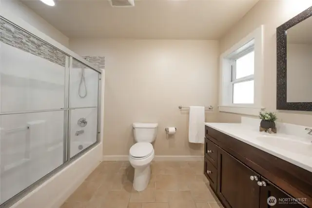 The full bath on the second floor is very spacious and features a tasteful vanity and tile floors.