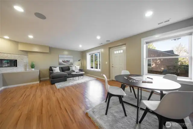 The expansive bonus room is located on the lower level and features a gas fireplace, wood floors, wet bar, and access to the fully fenced grounds.