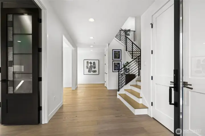 Open and welcoming entry foyer with the office on the left. Chaffey Building Group always have exquisite millwork wrapped doorways and windows. Gorgeous warm color to the wide plank engineered hardwoods.