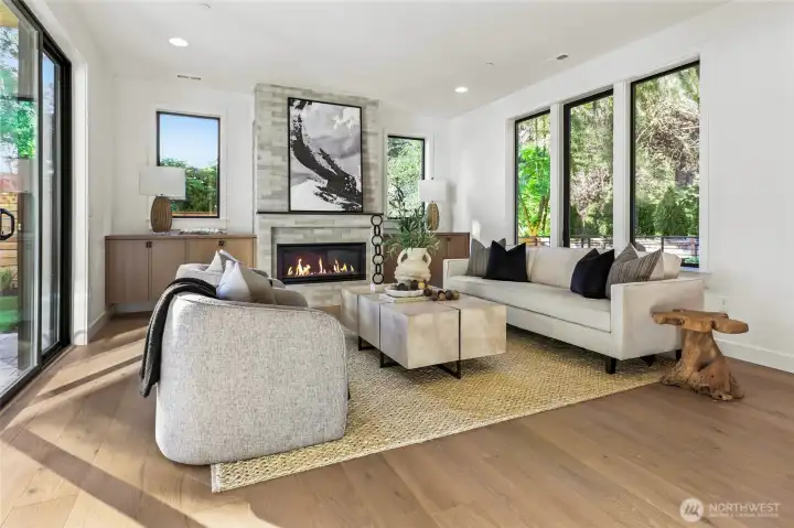 Family room full of windows provide views of the scenic landscaping from every angle.