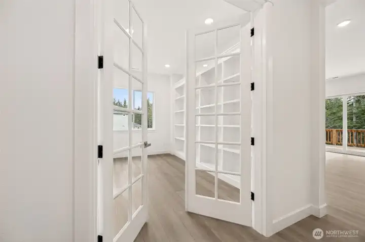 Study/den with French doors and built-ins  Photos are of a different home. Standard finishes and features are similar and can be modified.