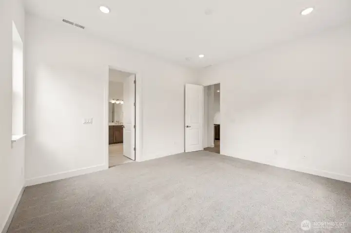 Primary bedroom. Photos are of a different home. Standard finishes and features are similar and can be modified.