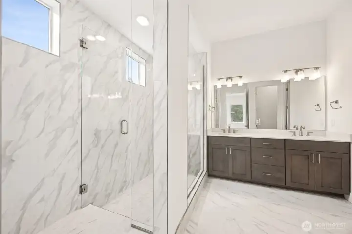 Primary bathroom with walk-in shower. Photos are of a different home. Standard finishes and features are similar and can be modified.