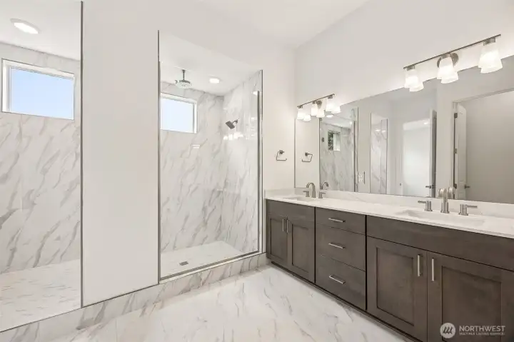 Primary bathroom with walk-in shower. Photos are of a different home. Standard finishes and features are similar and can be modified.