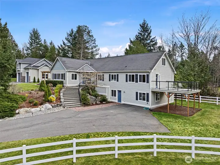 Front Elevation & Entry – A charming view of the home’s main entry set within a peaceful, private setting that reflects the estate’s inviting country character.