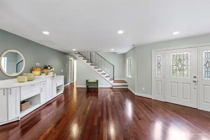 Foyer Facing Front Door – The entry foyer welcomes you with rich Brazilian cherry hardwood floors, setting the tone for the quality and warmth found throughout the home.