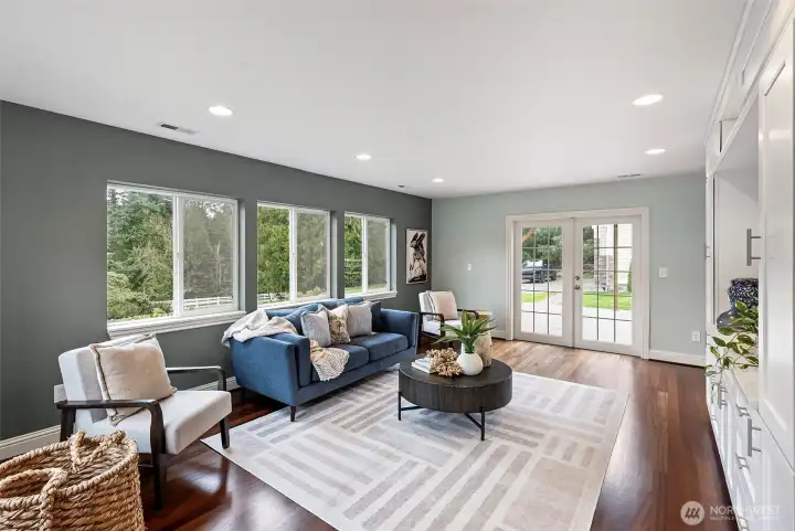Living Room Facing Deck – The living room features French doors that open to the back deck, allowing natural light to fill the space and seamlessly connecting indoor and outdoor living.