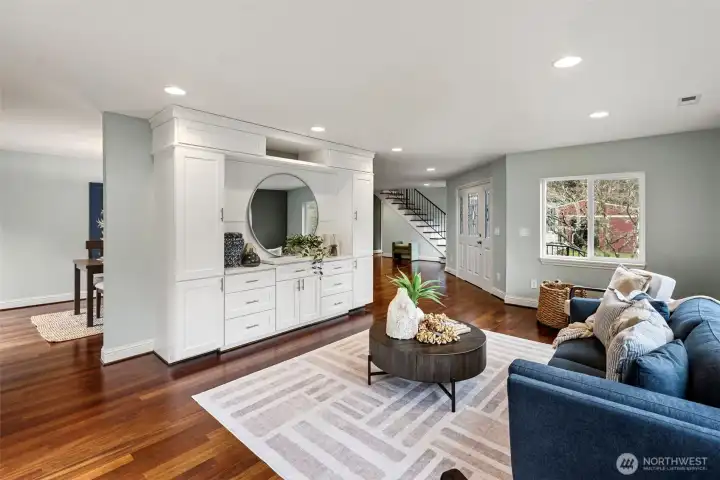 Living Room Facing Foyer – A comfortable gathering space with warm hardwood floors and open sightlines back toward the entry.