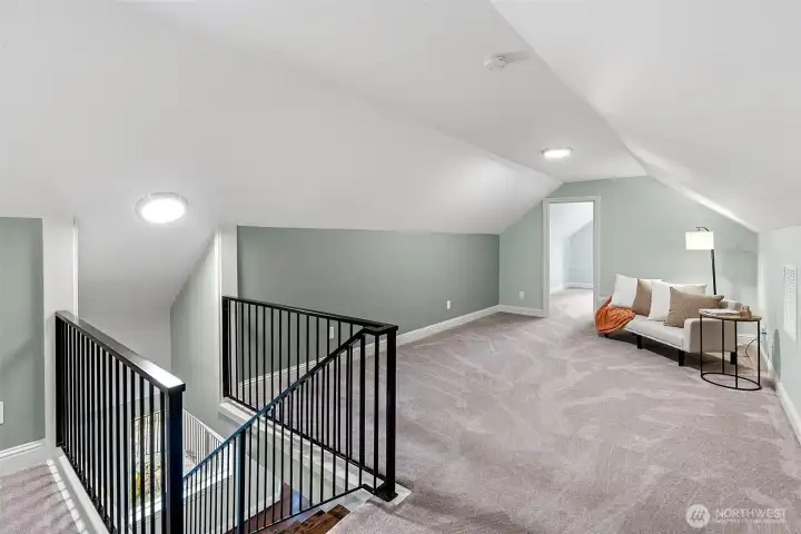 Second Story Loft – The upper-level loft offers additional living or recreation space and is accessed by stairs featuring elegant iron railing.