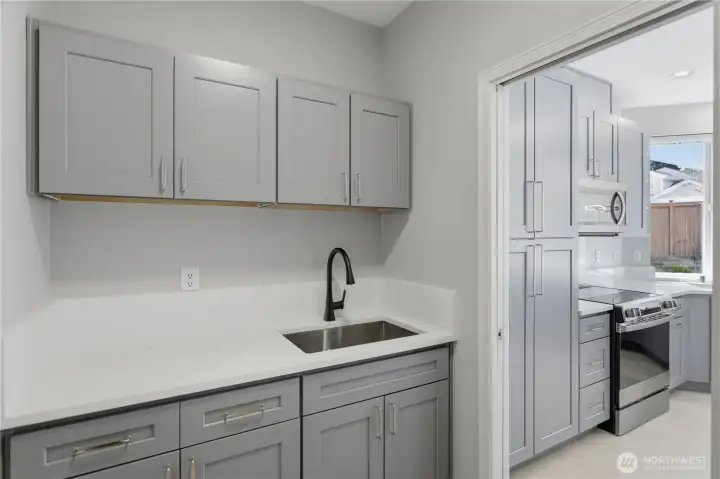 Laundry with cabinets and sink