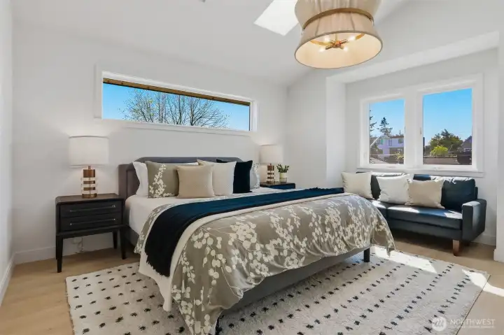 3rd floor primary bedroom with vaulted ceiling and 2 skylights.