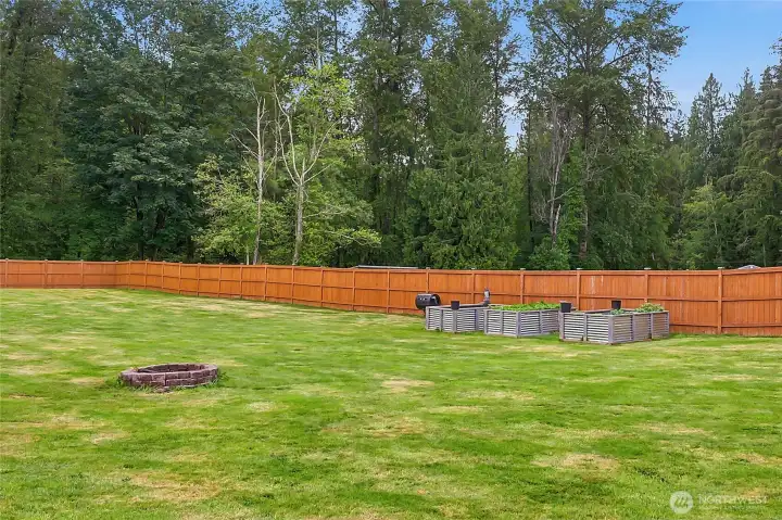 Vegetable beds, fruit trees and wood-burning firepit.