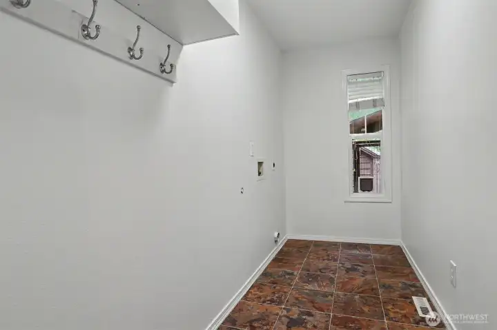 Laundry room off the kitchen. Keeps the noise downstairs. Laundry room off the kitchen. Keeps the noise downstairs.