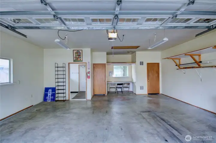 Dry walled and insulated over sized garage with storage closet, utility closet (water heater and furnace) and shop space. Drop down ceiling latter for abundant above garage storage