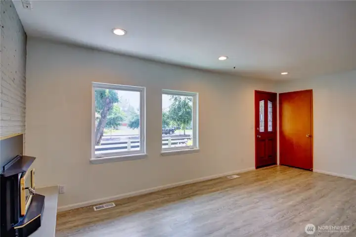 Living room showing coat closet and front door