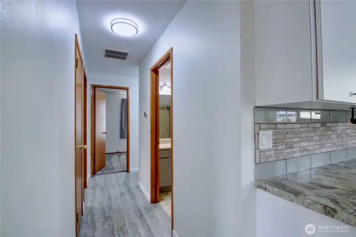 Main hallway to full bath (right) linen closet and 2 bedrooms