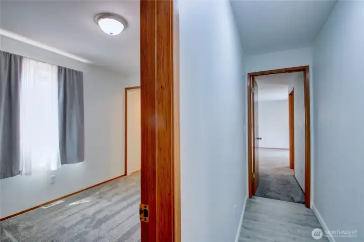 Showing bedroom 2 on left and hallway to primary bedroom on the right
