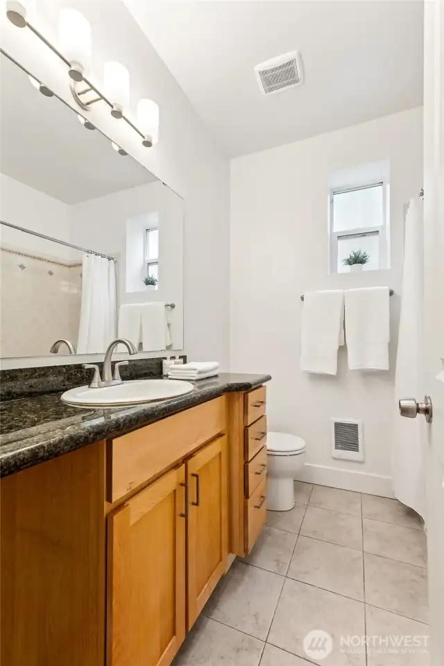 Bathroom situated between the two bedrooms.