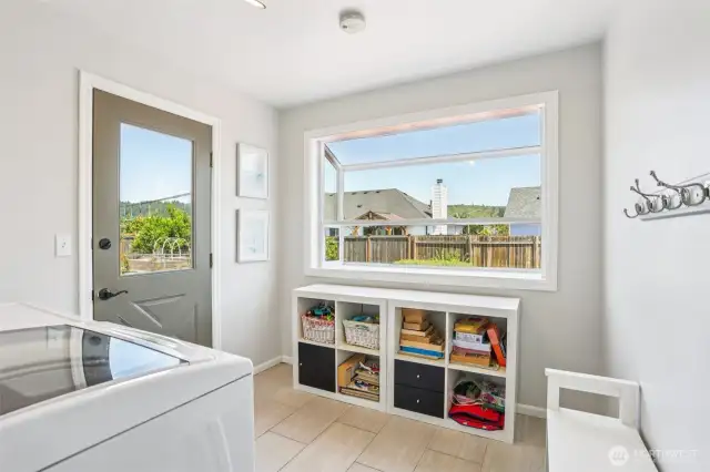 Laundry room on main floor with garden window. nice and bright with morning sun!