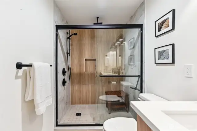 Huge primary shower is ideal! Wood accents showcase the thought to detail in the home.