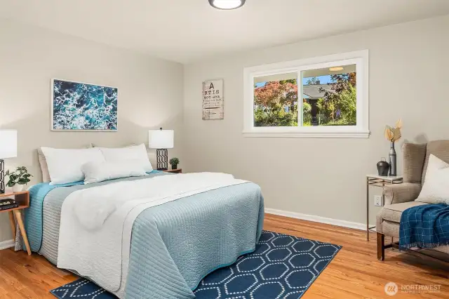 First guest bedroom is very spacious and looks out onto the peaceful neighborhood. Gorgeous oak hardwoods have been refinished. Picture from previous listing.