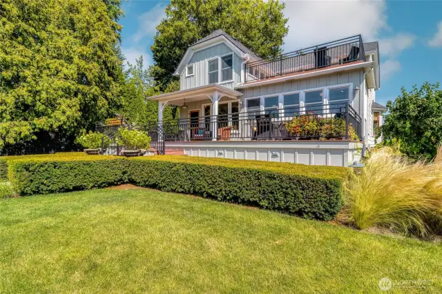 Back View of the home with an upper deck & lower patio