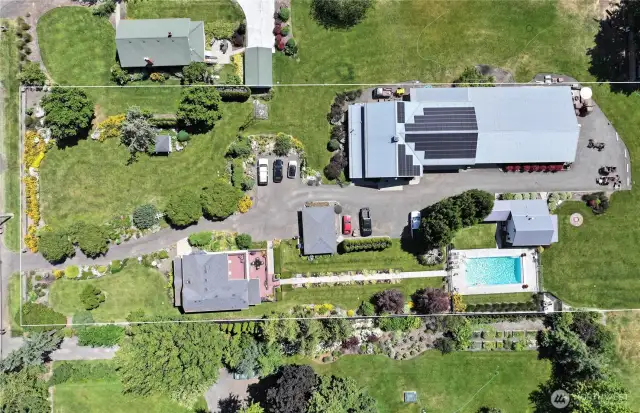 Spacious 2.440 acres with Historic Home, detached garage, Short term Rental/VRBO plus the shop of your dreams.