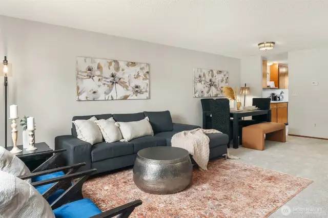 The cohesive living and dining areas meet seamlessly, great for casual or formal entertaining!