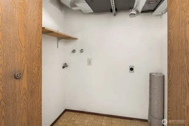 Main floor laundry room and mechanical room.  Privacy doors are great for keeping laundry private!