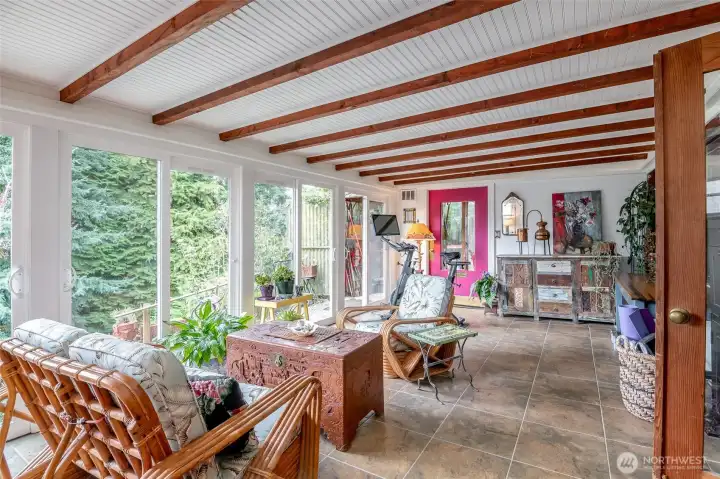 Welcome to this sunroom with a walls of windows just off the primary bedroom.