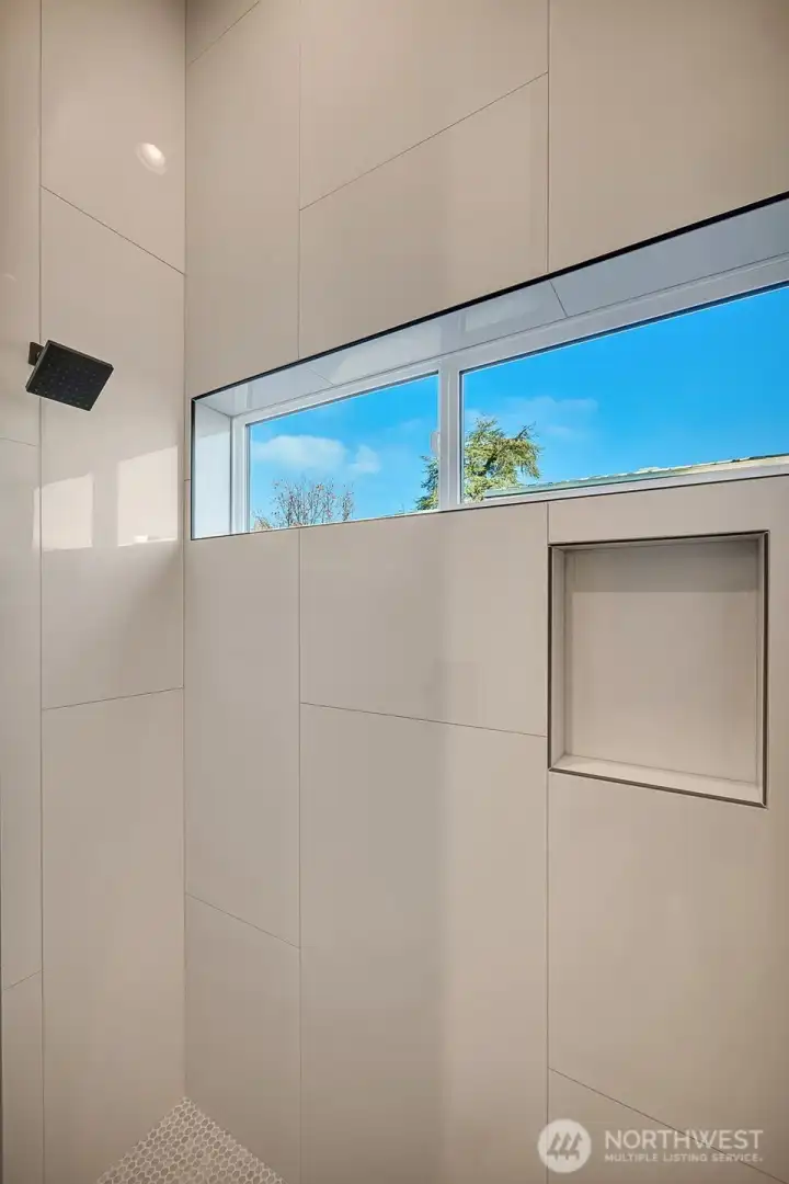 Primary ensuite features walk-in shower and vanity.