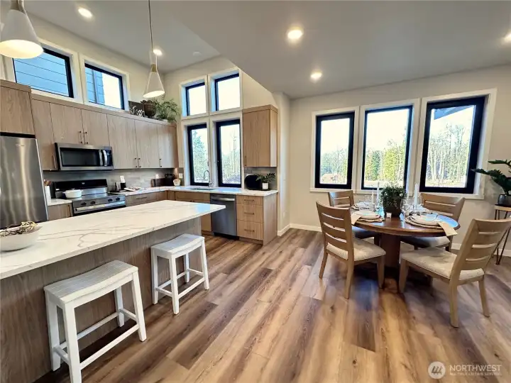 Large kitchen with great island, transom windows, dining space and lovely natural light throughout.