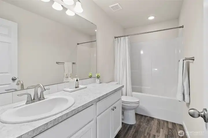 Upstairs full bath with generous counter space.